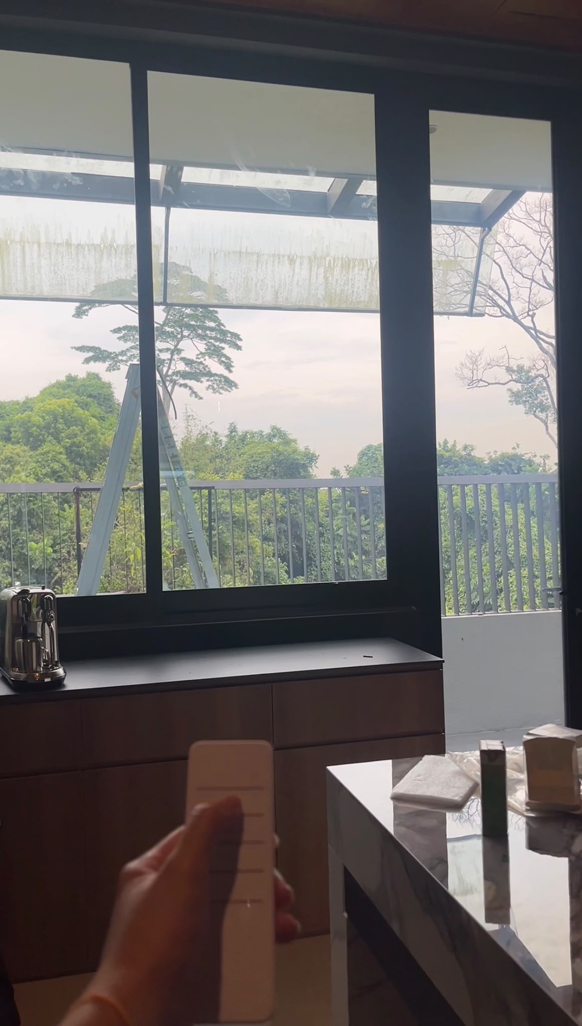Glass panel partway through smart film application