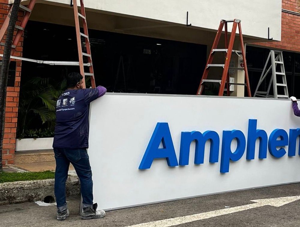 Installing raised 3D letters onto signboard, Amphenol Singapore
